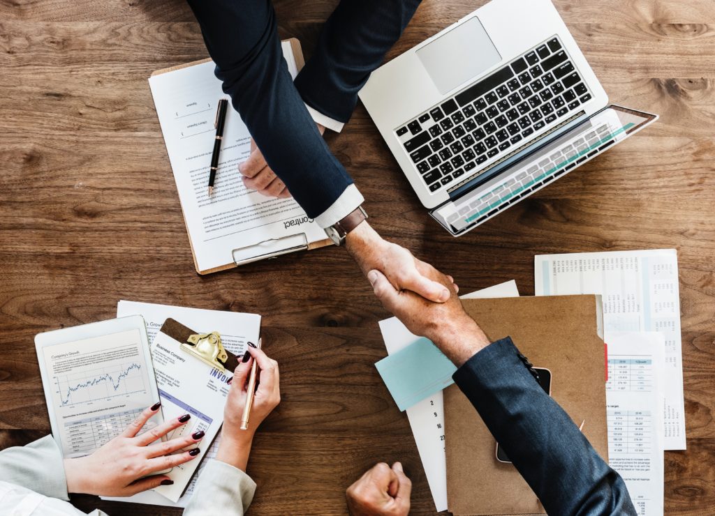 A business meeting, two people are shaking hands