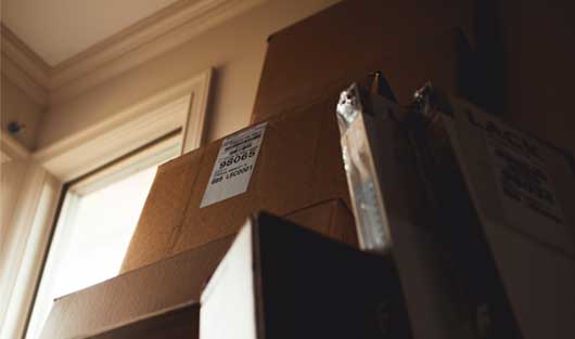 Moving boxes leaning against a wall
