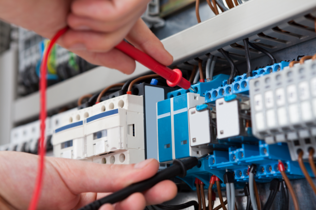 Electrical technician plugging in wires