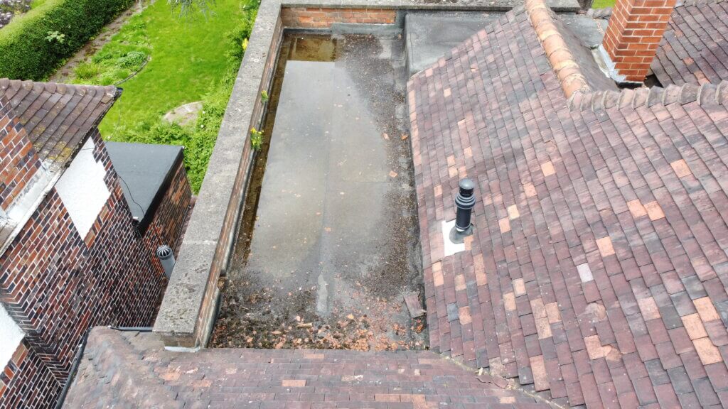 alt="drone view of pooling water on flat roof found by surveyor in leicester"