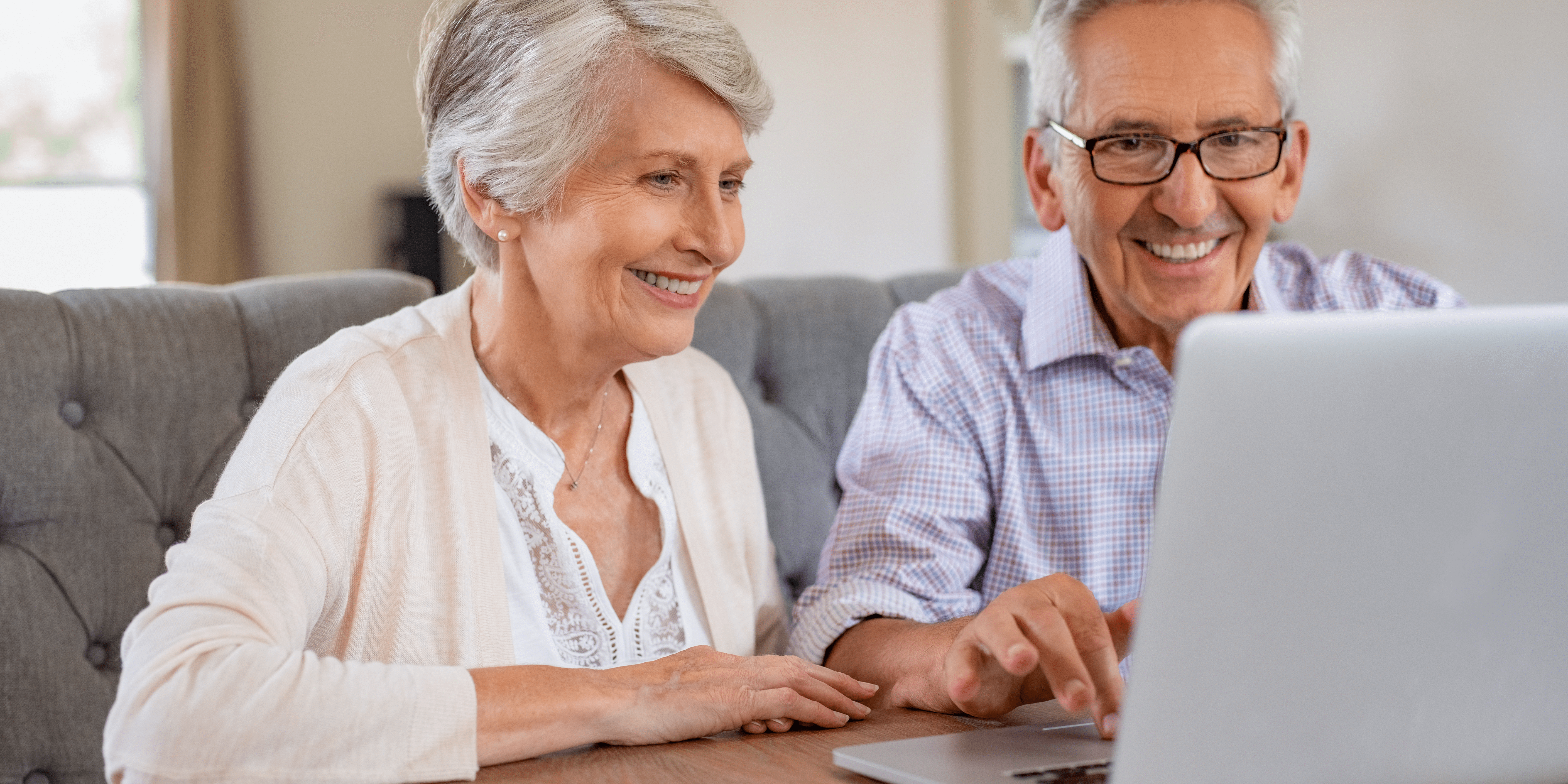 Couple smiling at Laptop screen. 