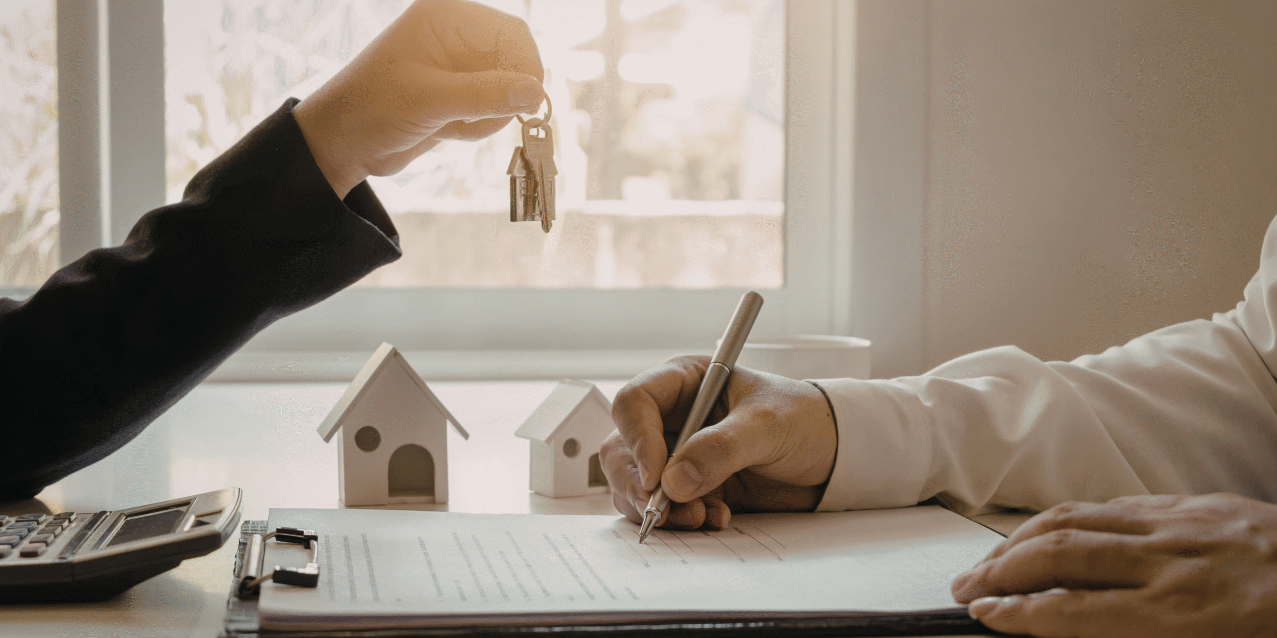 Signing documents and handing over house keys.